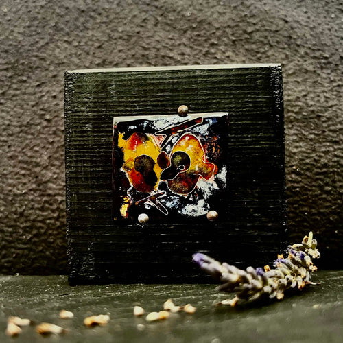 Baby Pigeons — vitreous enamel on copper miniature, 40 × 36 mm, fine silver cloisonné, kiln-fired. Warm amber, red and dark tones depicting two baby pigeons in a nest. Displayed on handmade black pine stand, 80 × 80 mm. House Zoo series by A. Fraction, Vilnius.