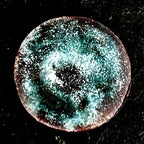 Magnetic Storm – original wet-packed vitreous enamel miniature on a round copper disc, front view on dark slate. Turquoise and white enamel with a stormy speckled texture and warm copper-red rim. Original one-of-a-kind piece by A. Fraction.