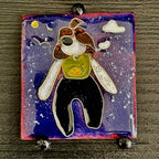 The Wild Within, House Zoo — The Wild We Live With. Full view flat lay on dark wood. Self-portrait figure floating in a navy blue sky with moon, cloud, and two birds. Cloisonné enamel on copper, 35 × 38 mm, A. Fraction.