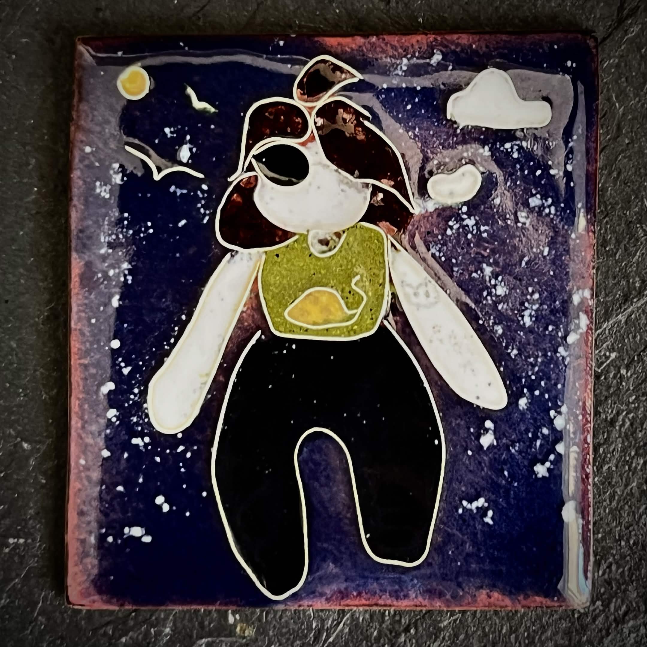 The Wild Within, House Zoo — The Wild We Live With. Original cloisonné enamel on copper, close-up flat lay. A self-portrait figure floats against a deep navy sky with outstretched arms, a yellow moon, white cloud, and bird silhouette. 35 × 38 mm, A. Fraction.