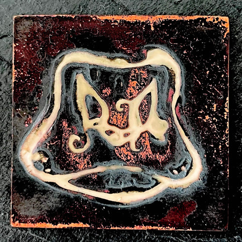 Cow's Hairy Nose - champlevé enamel on copper, cream-coloured recessed lines forming a surrealist cow nose with curling hairs on a deep dark fired oxidised copper, by A. Fraction