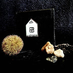 Little House displayed on handmade matte black pine stand, styled with natural found objects, enamel miniature by A. Fraction